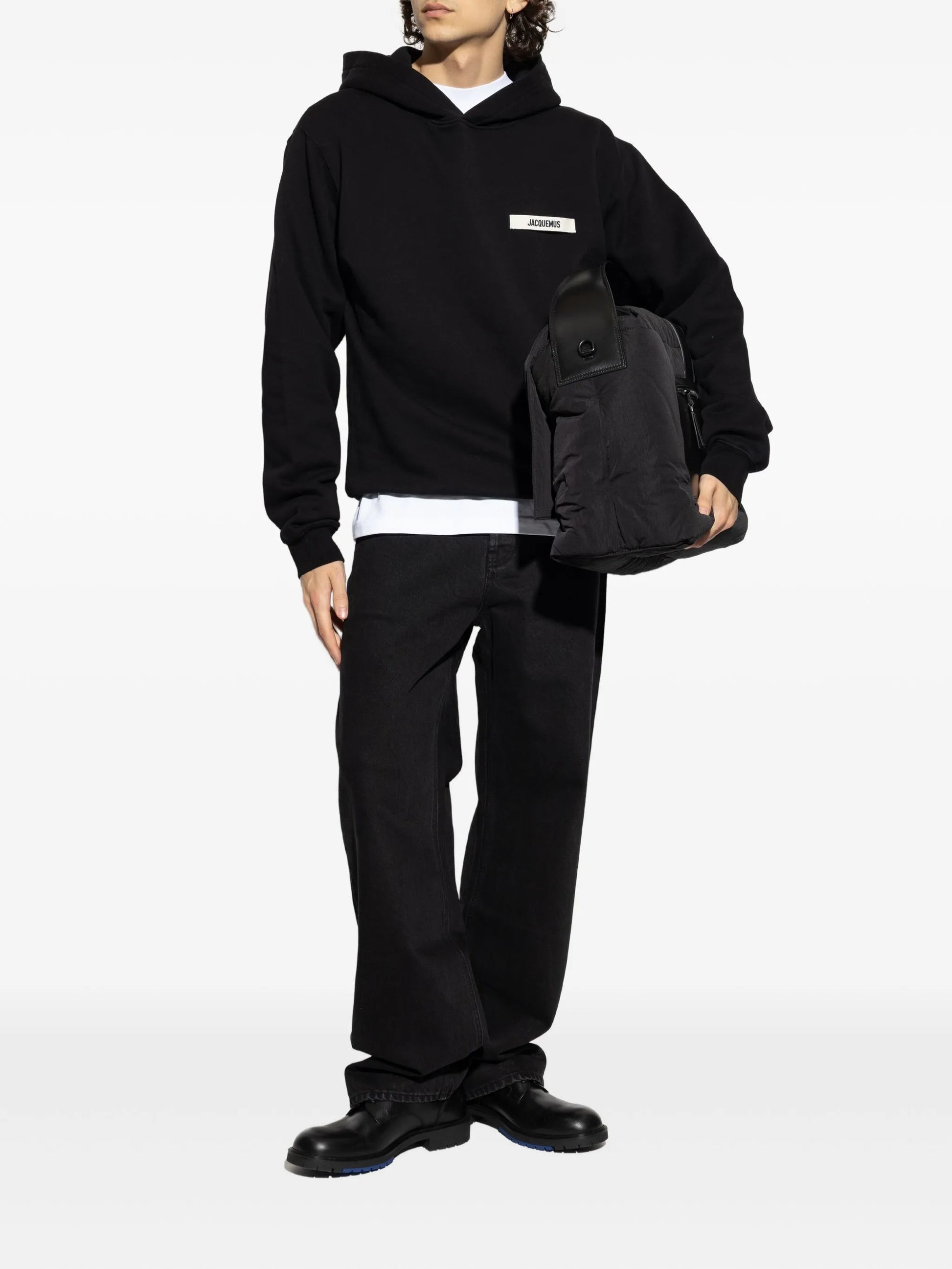 Black hoodie with a small logo on the chest against a white background
