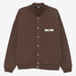 Brown jacket with a visible brand label on a white background