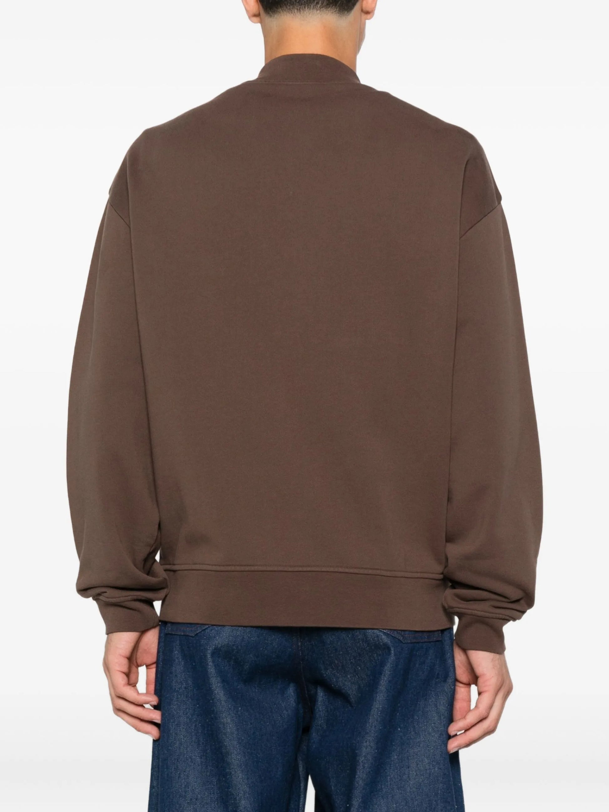 Brown jacket with a visible brand label on a white background