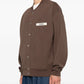 Brown jacket with a visible brand label on a white background