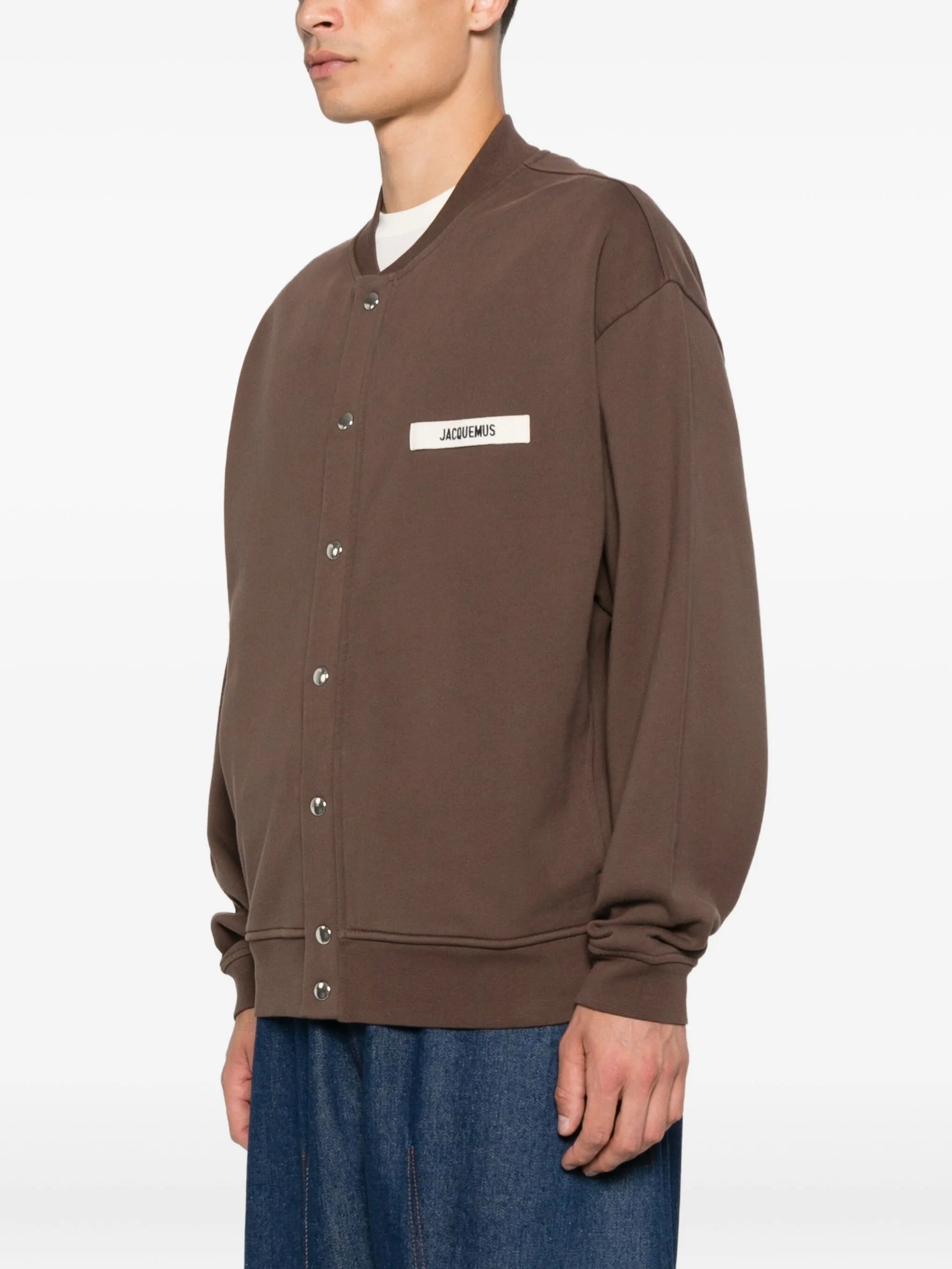 Brown jacket with a visible brand label on a white background