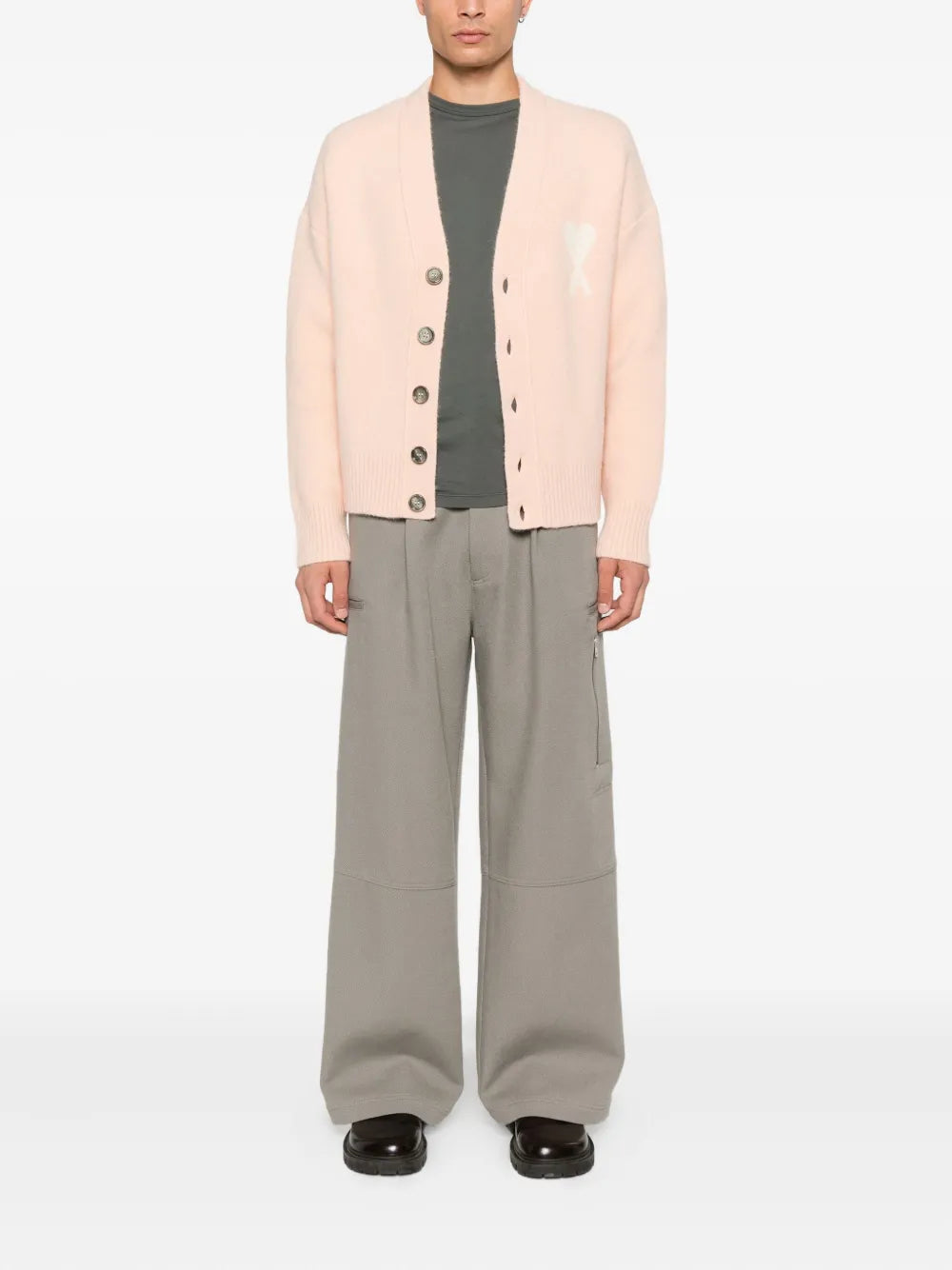  Pink cardigan with button details and a bow design on a white background ami paris