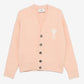 Pink cardigan with button details and a bow design on a white background ami paris
