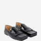 Pair of black loafers on a white background