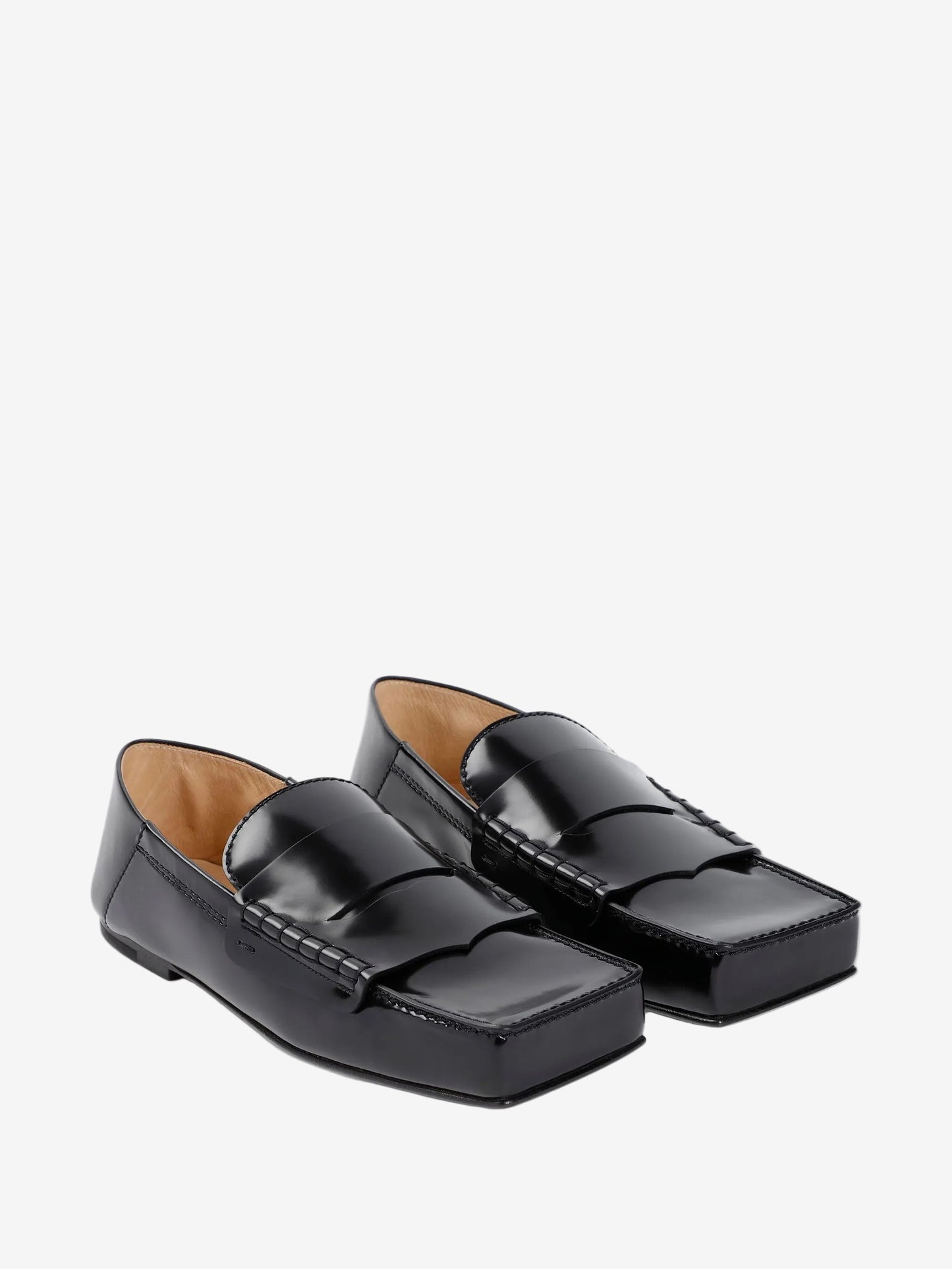 Pair of black loafers on a white background