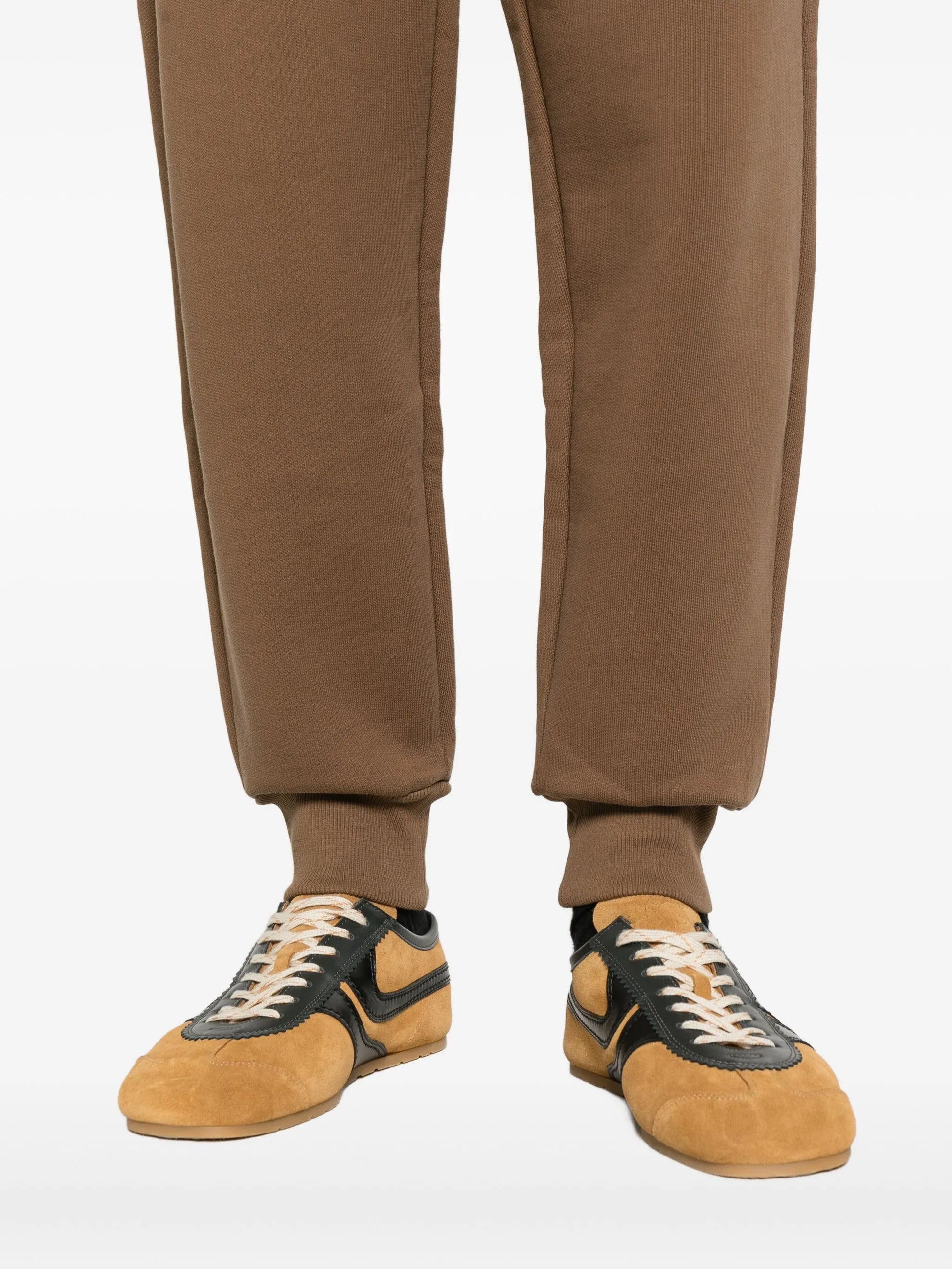 Brown sweatpants with a drawstring on a white background