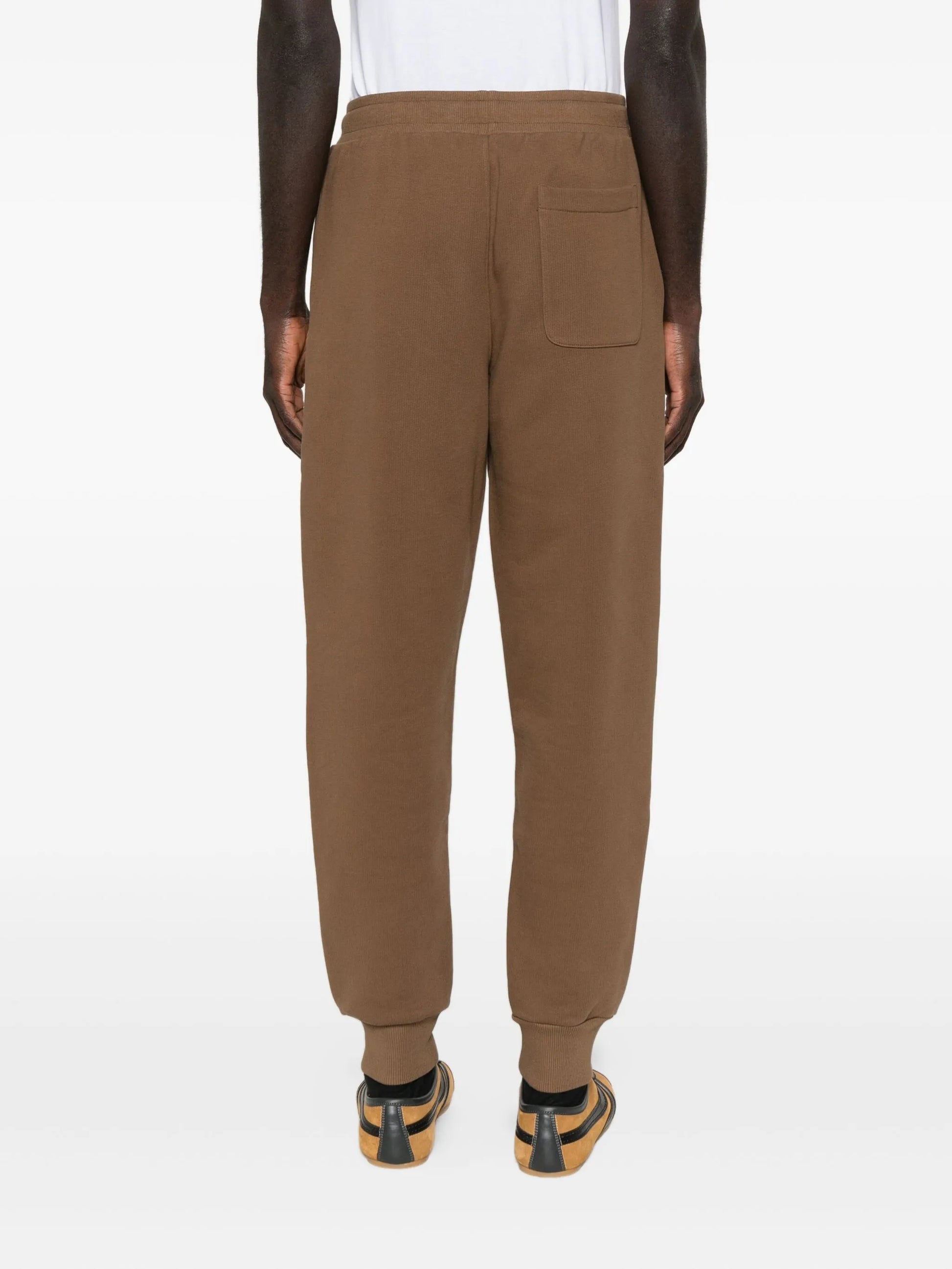 Brown sweatpants with a drawstring on a white background