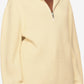 Woman wearing a beige hoodie with a zipper, standing against a neutral background