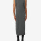 Woman wearing a gray sleeveless dress on a white background
