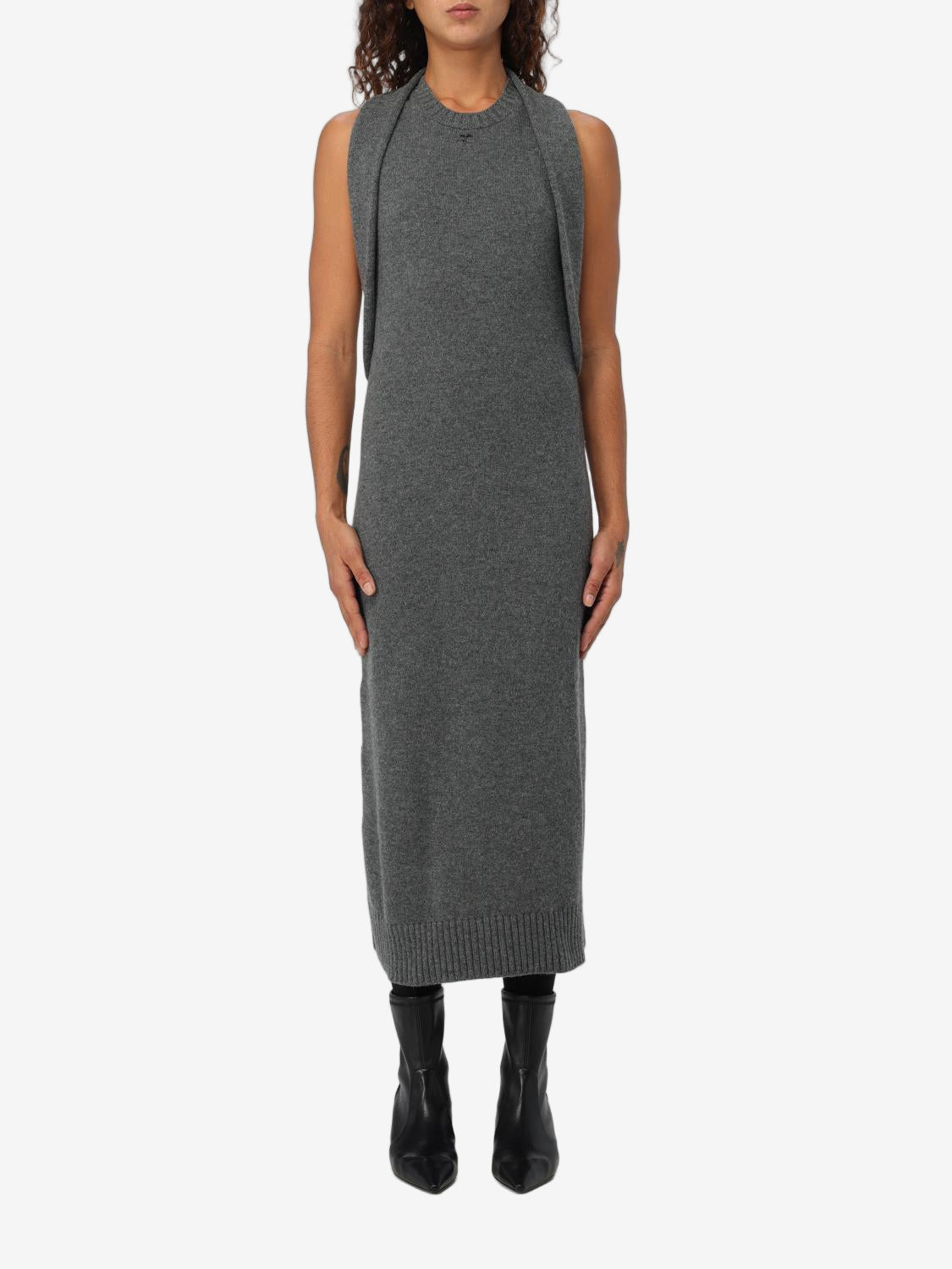 Woman wearing a gray sleeveless dress on a white background