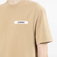dark beige t-shirt with a small logo on a white background