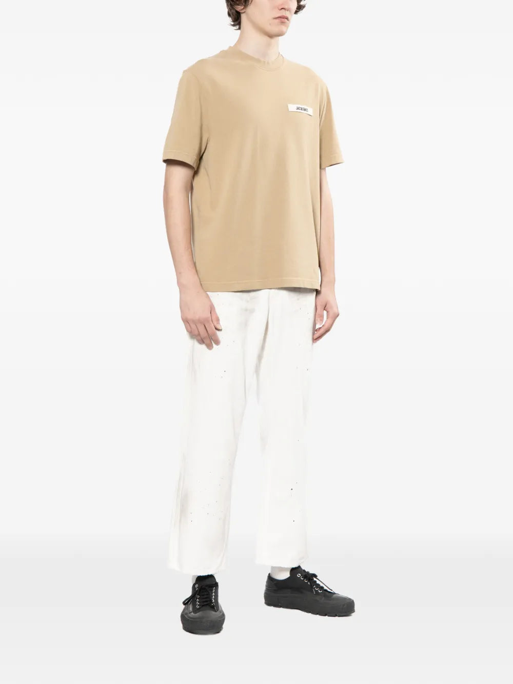 dark beige t-shirt with a small logo on a white background