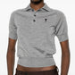 Gray polo shirt with a small logo on a white background