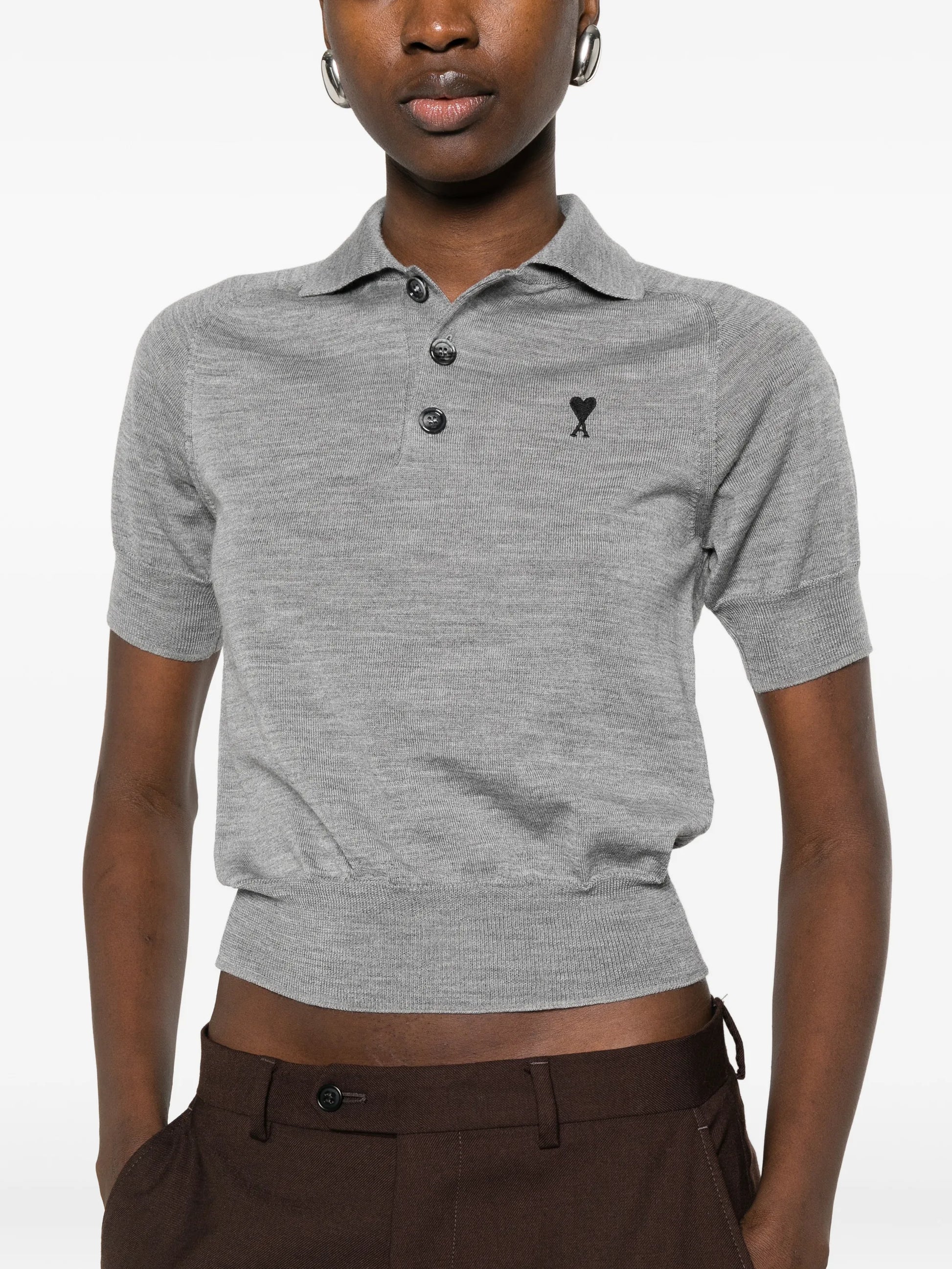 Gray polo shirt with a small logo on a white background