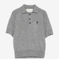 Gray polo shirt with a small logo on a white background