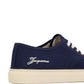 Navy blue sneaker with white laces on a white background