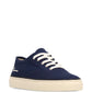 Navy blue sneaker with white laces on a white background