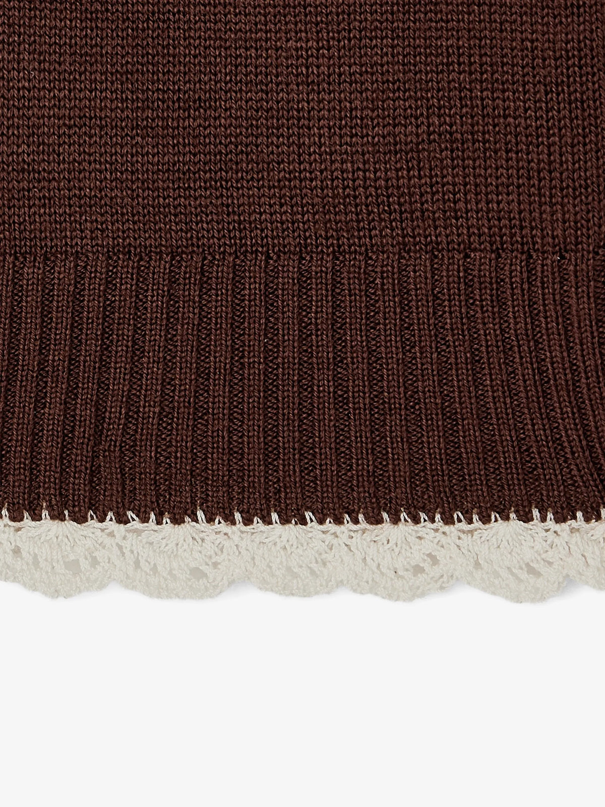 A dark brown knit sweater with a small white embroidered heart logo on the left chest, displayed flat against a light gray background.
