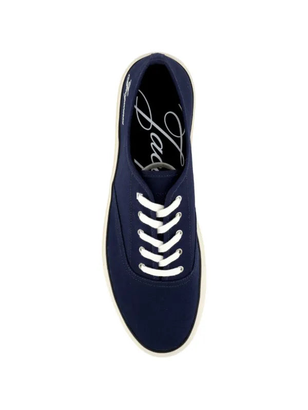 Navy blue sneaker with white laces on a white background