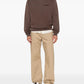 brown hoodie with a small logo on the chest against a white background