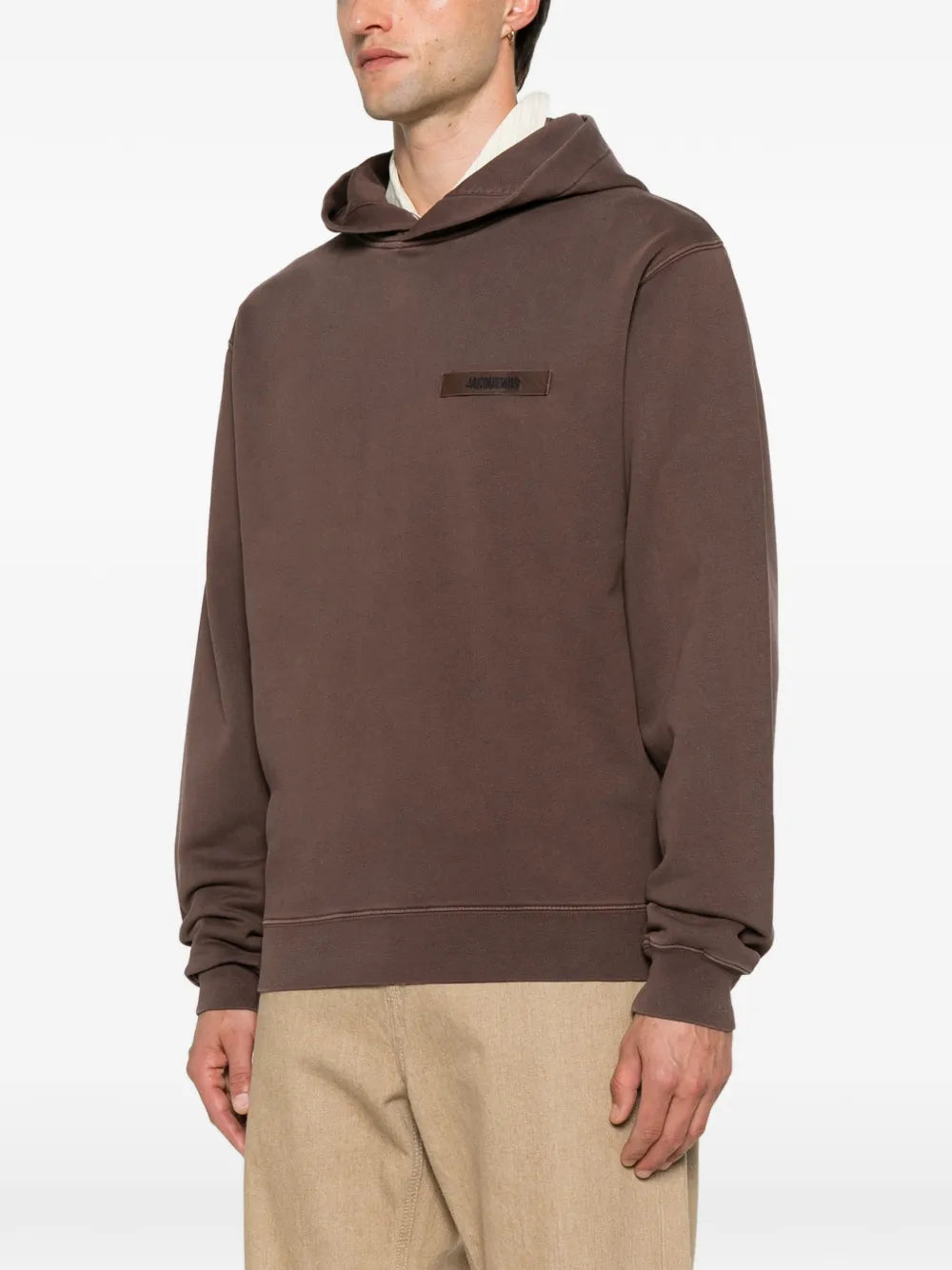 brown hoodie with a small logo on the chest against a white background