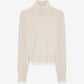 A light beige knit turtleneck sweater with long sleeves and a sheer ruffled hem, displayed against a plain white background.