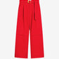 Red pants with a belt on a beige background