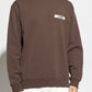 Brown sweatshirt with a small logo on a white background