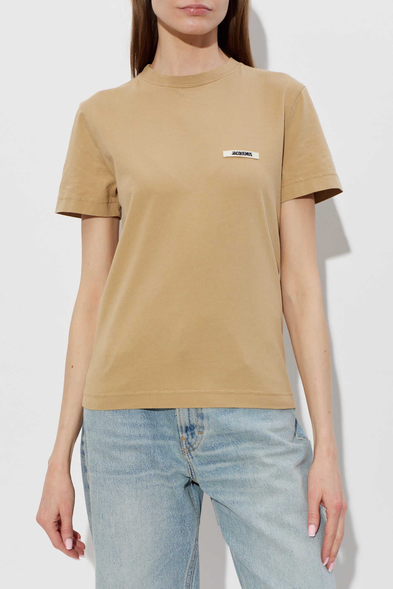 dark beige t-shirt with a small logo on a white background JACQUEMUS