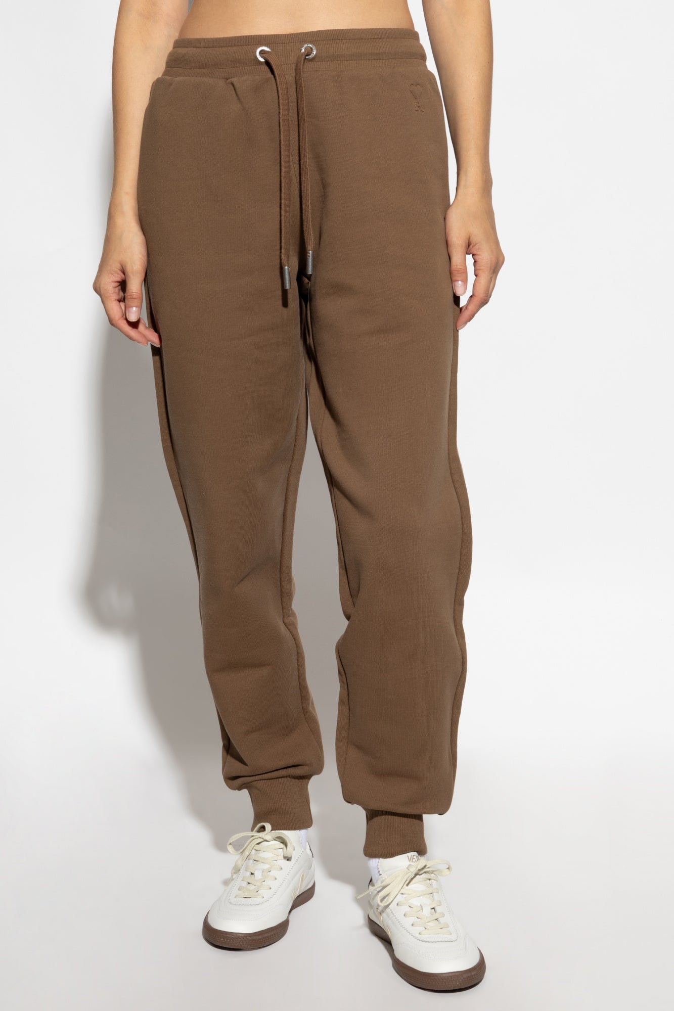 Brown sweatpants with a drawstring on a white background