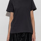 A black short-sleeve crewneck t-shirt by Maruti, shown flat against a plain white background.
