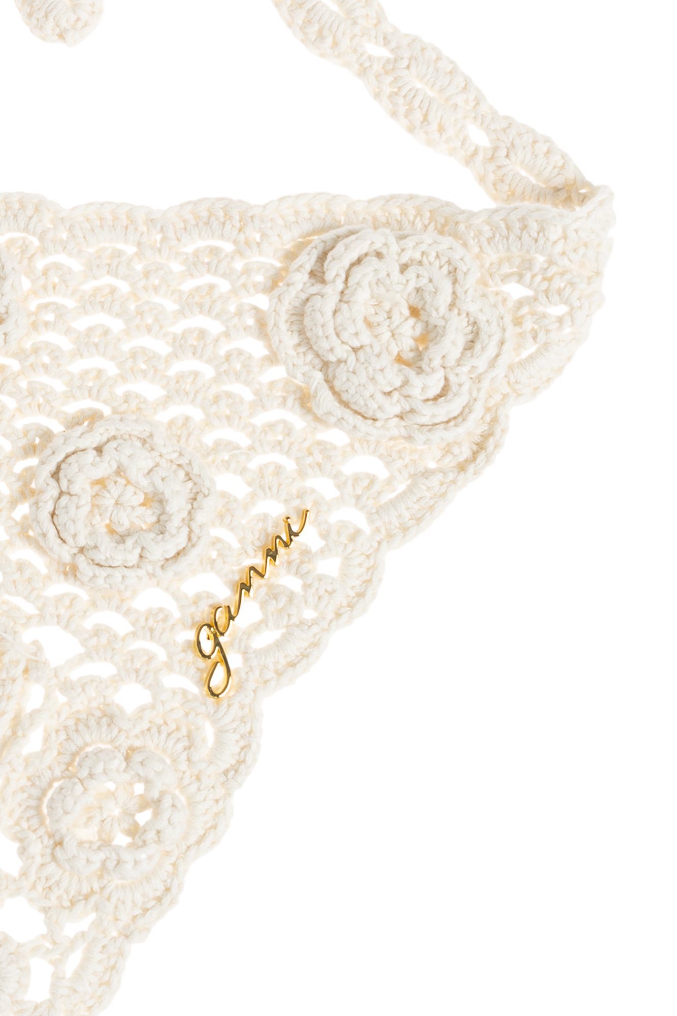 White crochet bikini top with floral details on a white background