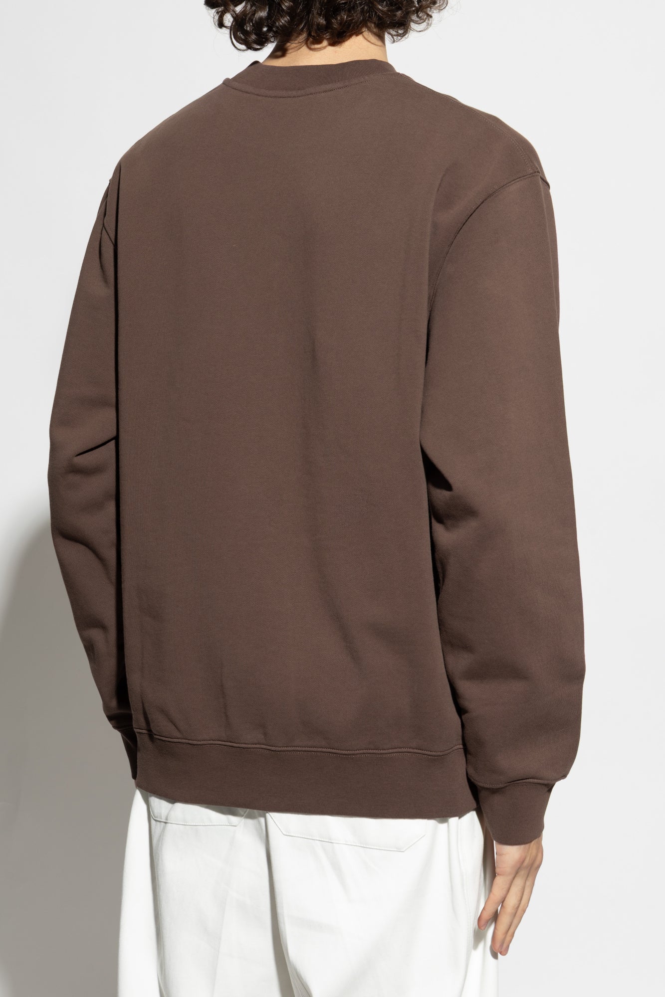 Brown sweatshirt with a small logo on a white background