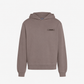brown hoodie with a small logo on the chest against a white background