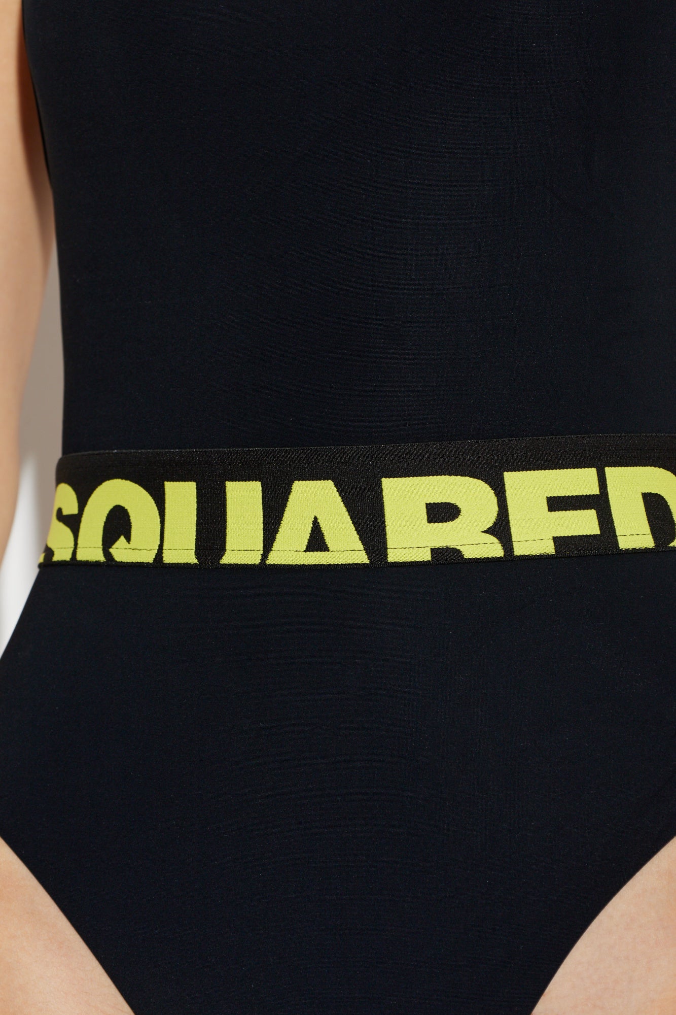 Black swimsuit with yellow logo on a white background