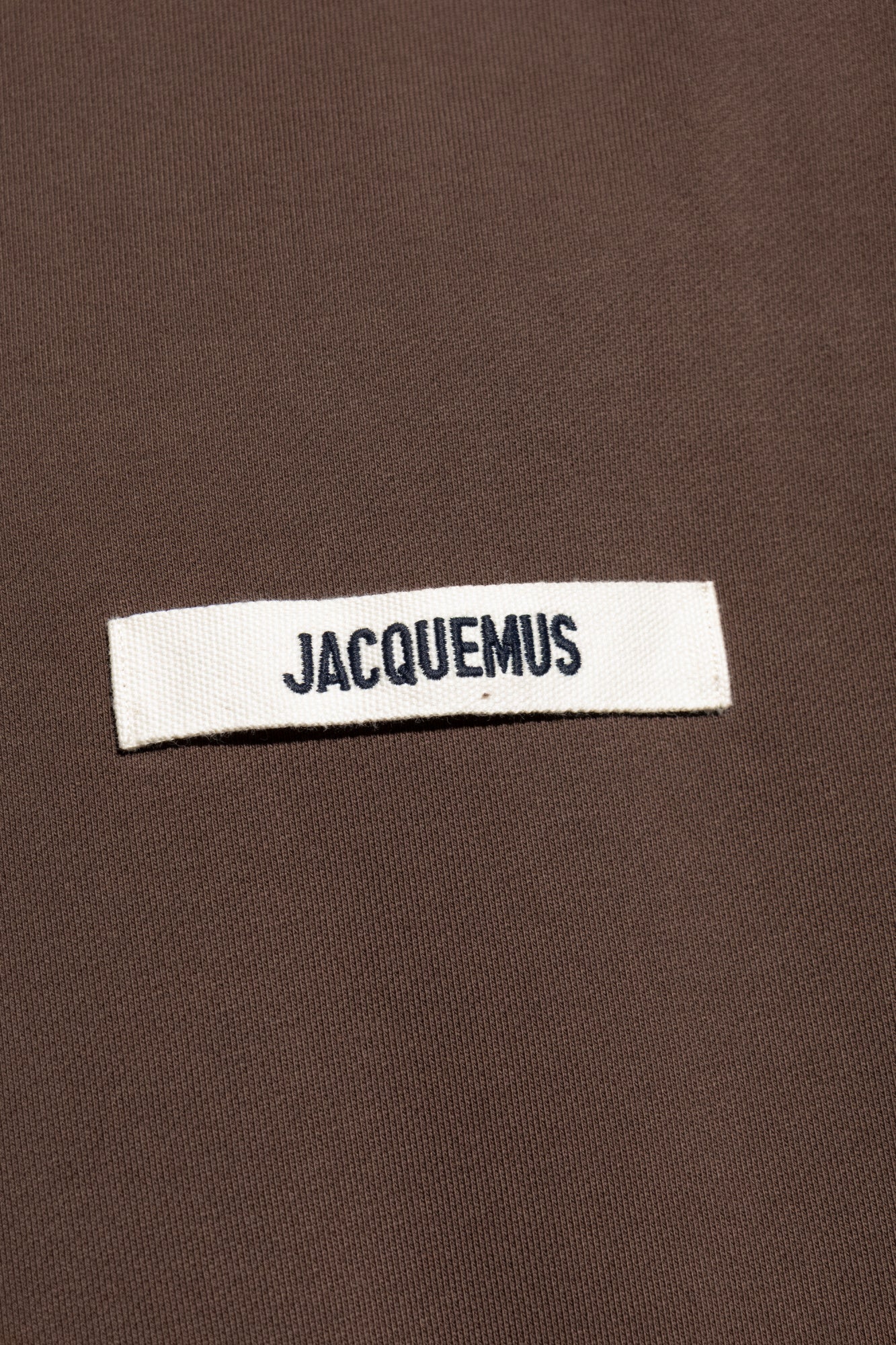 Brown sweatshirt with a small logo on a white background