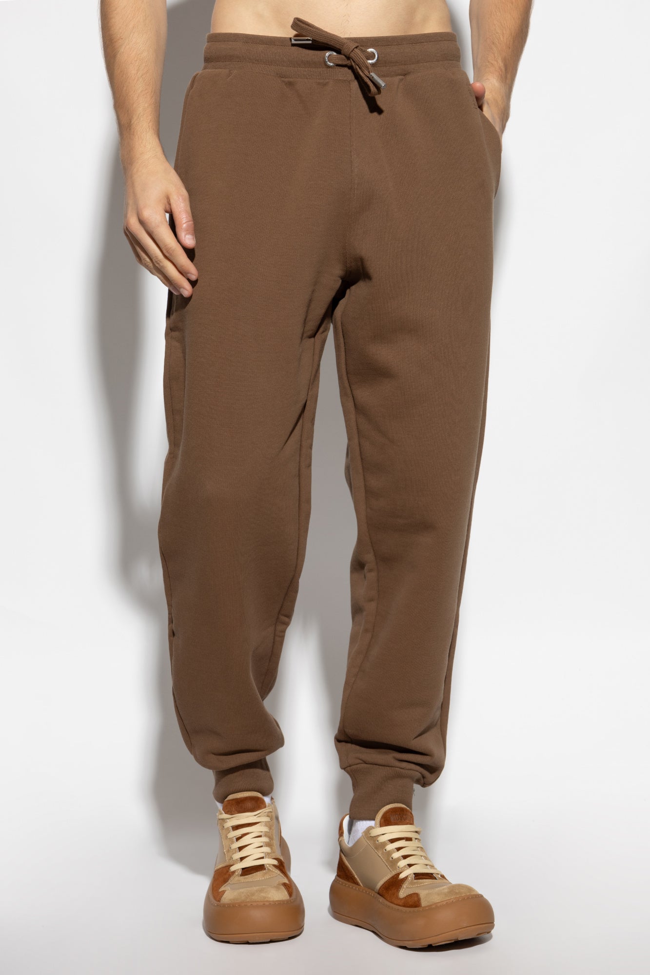 Brown sweatpants with a drawstring on a white background