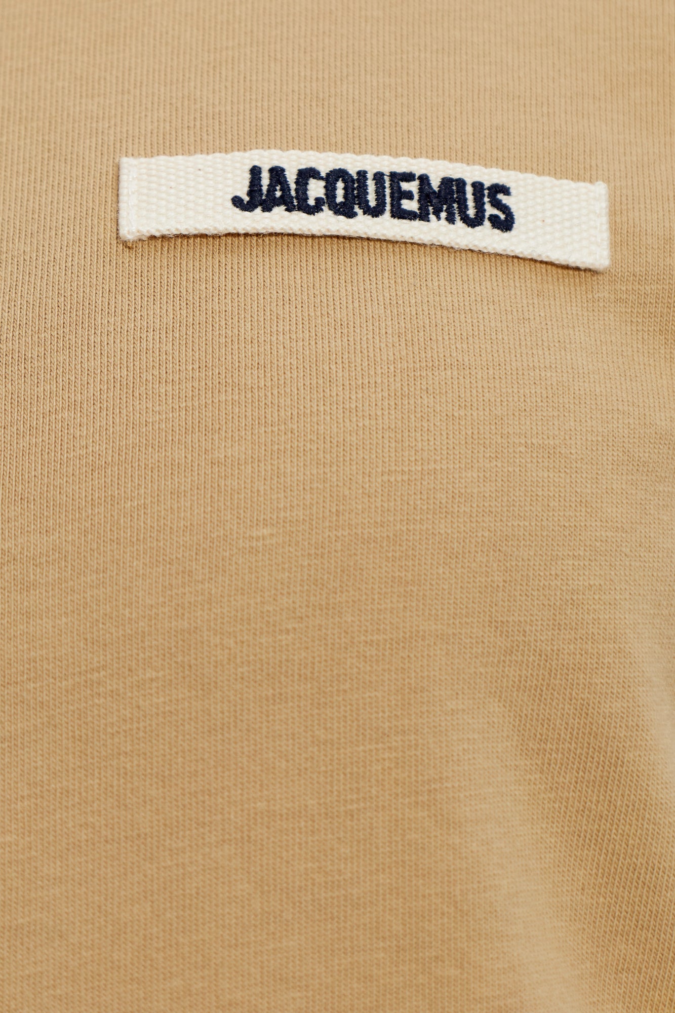 dark beige t-shirt with a small logo on a white background JACQUEMUS