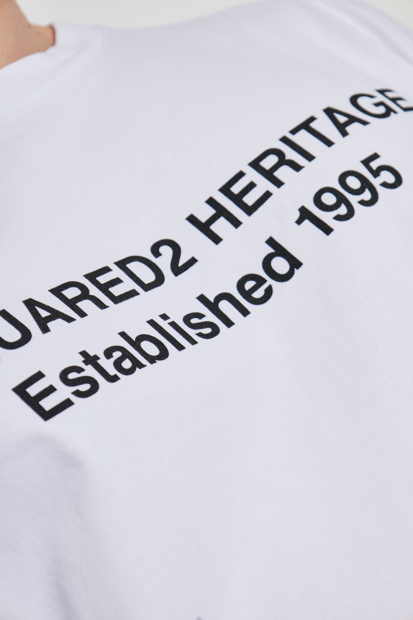 White t-shirt with black text on a white background
