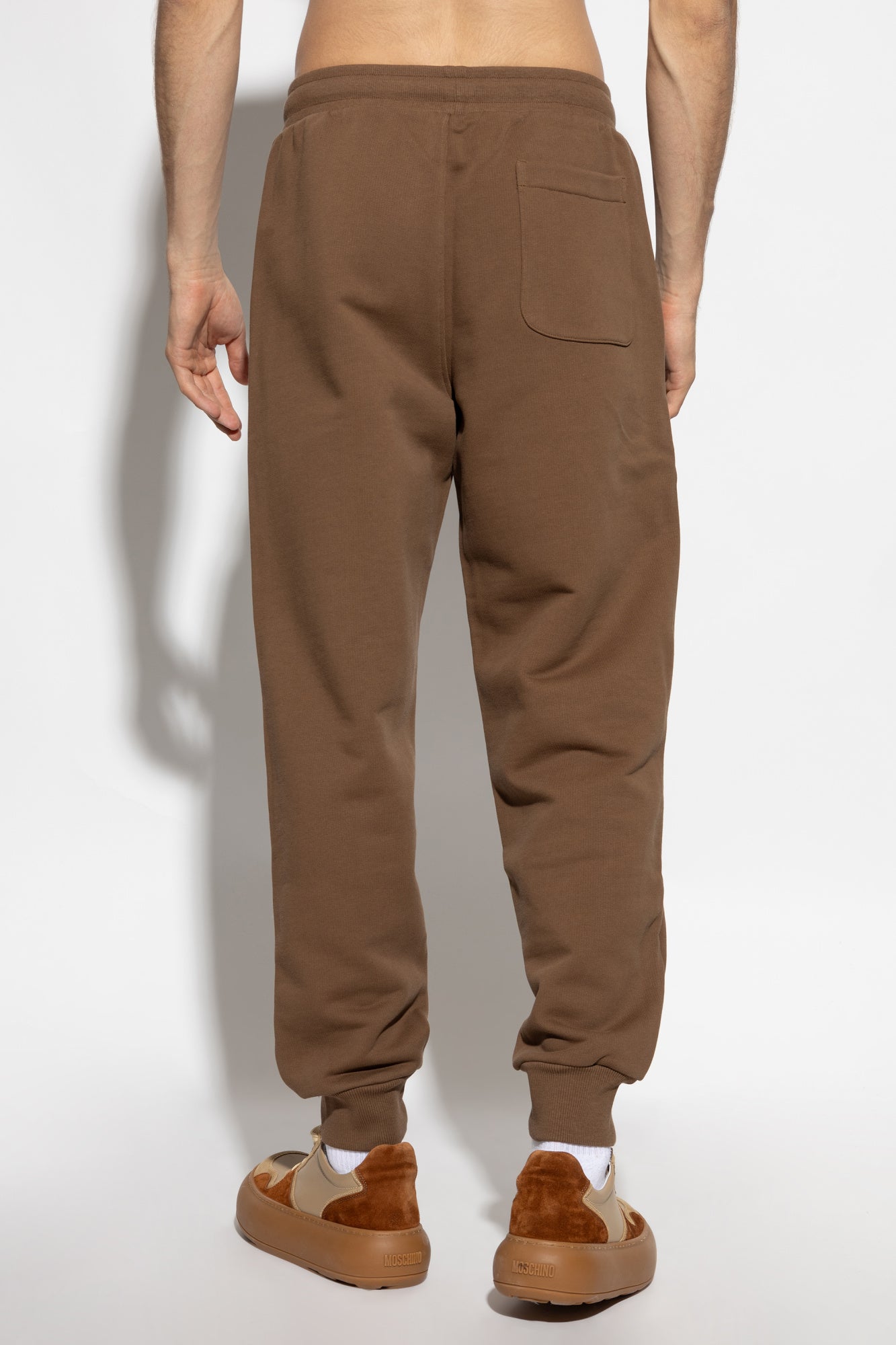 Brown sweatpants with a drawstring on a white background