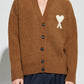 Brown cardigan with a heart and letter 'A' design on a white background ami paris
