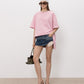 A light pink short-sleeve t-shirt with a small tonal pink ATTICO' logo on the left chest, displayed on a neutral light gray background.