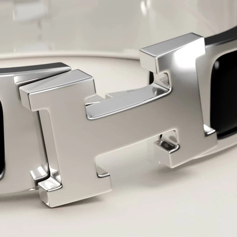 Silver bracelet with black accents on a light gray background