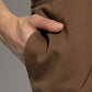 Brown sweatpants with a drawstring on a white background