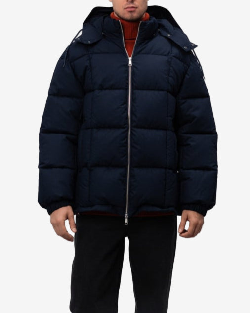Man wearing a navy blue puffer jacket on a white background