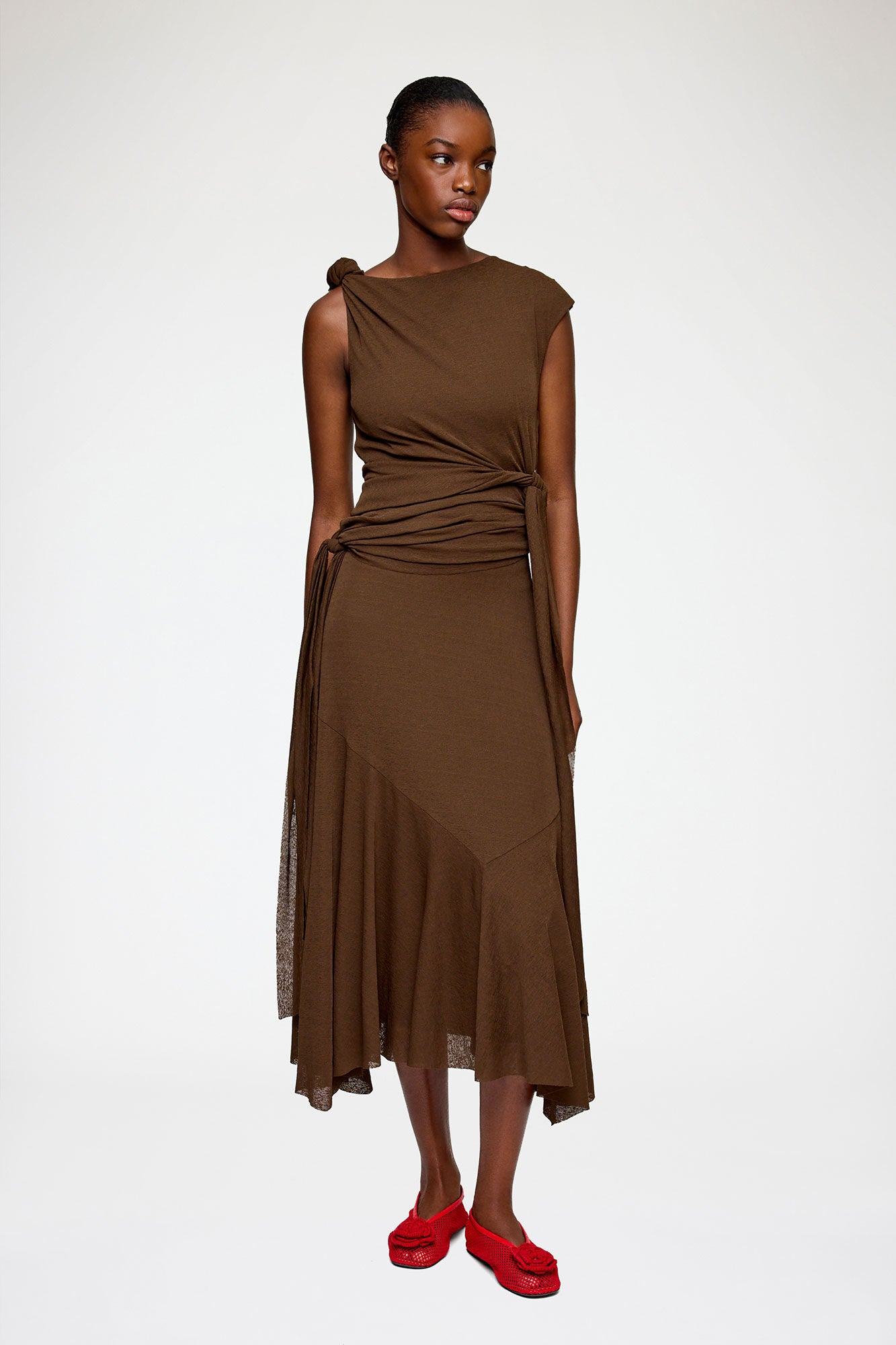 Brown sleeveless dress with a draped design on a white background