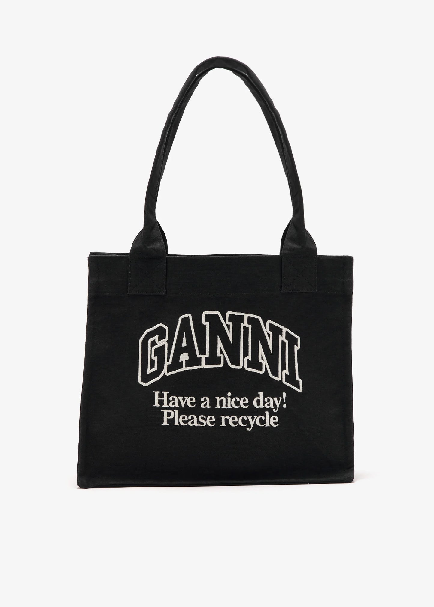 Black tote bag with 'Ganni' branding and text on a white background