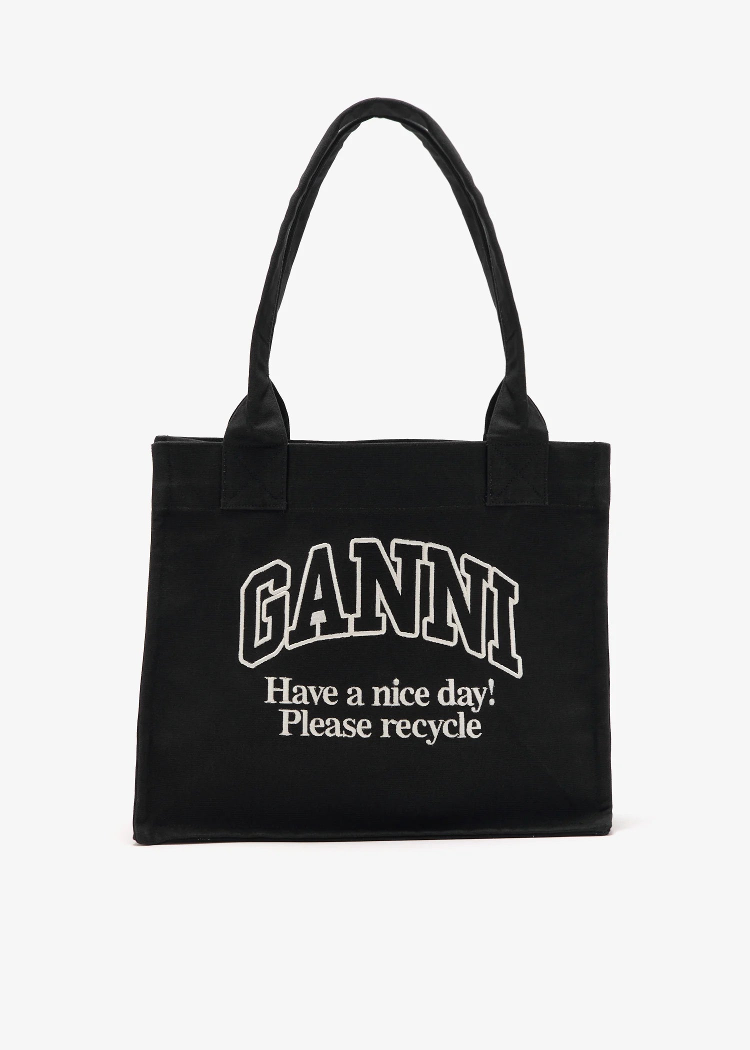 Black tote bag with 'Ganni' branding and text on a white background