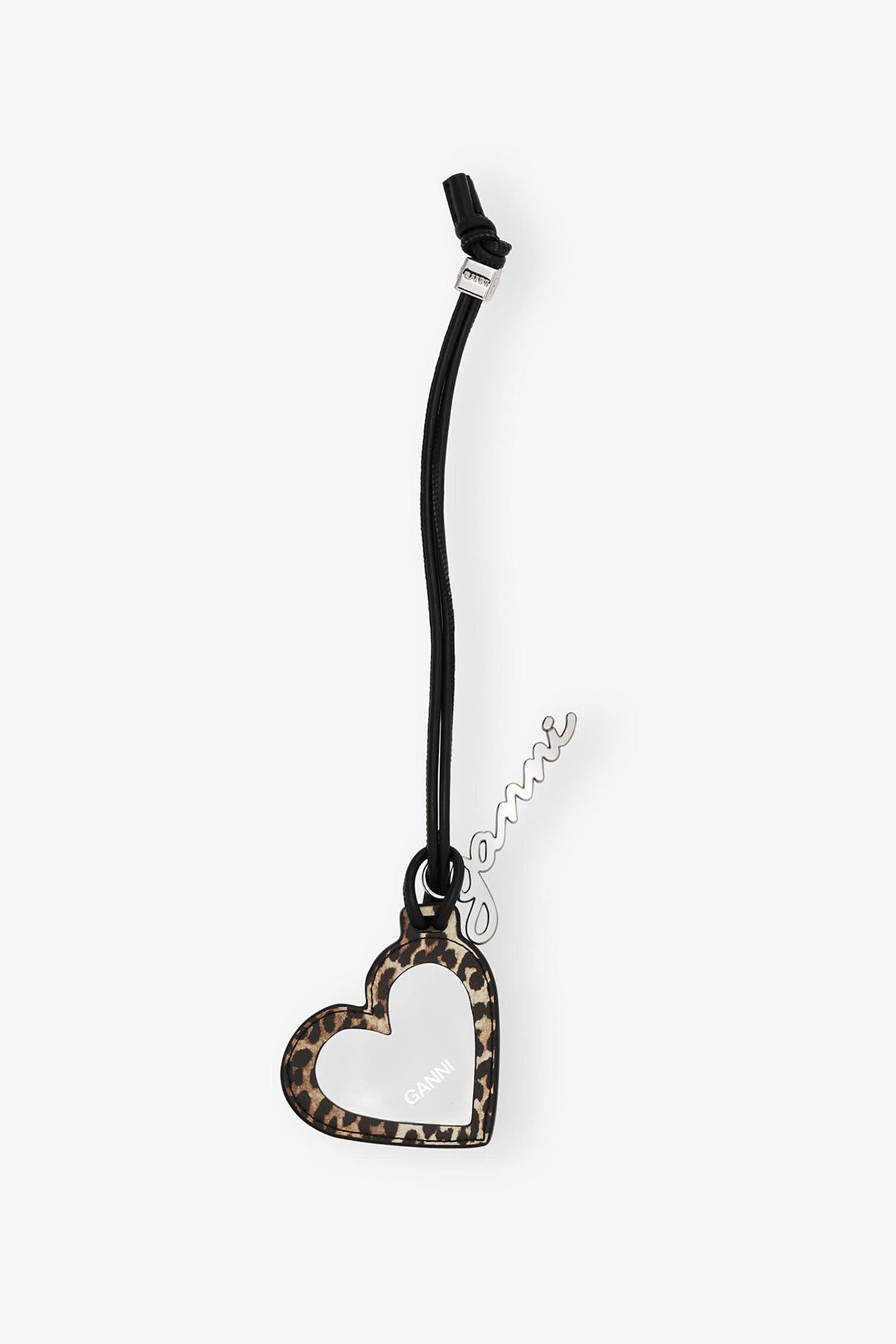 Heart-shaped pendant with leopard print on a black cord against a white background