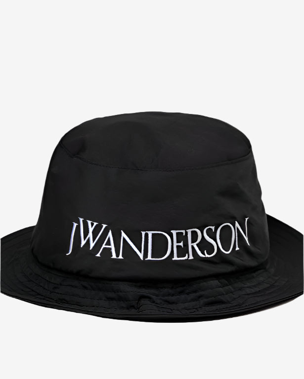 Black bucket hat with 'JW Anderson' branding on a white background